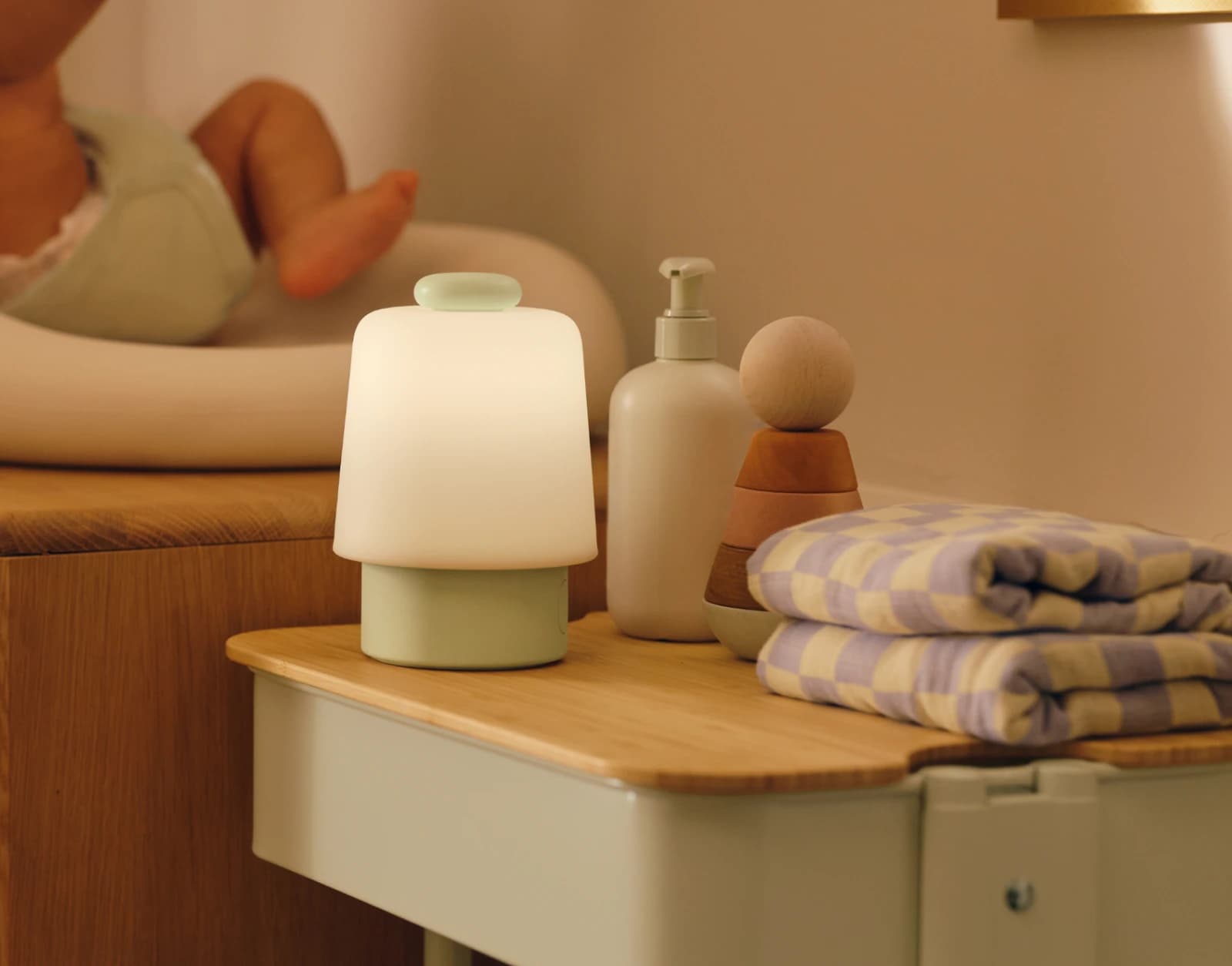 Hatch Baby Mint sitting on a nursery changing table